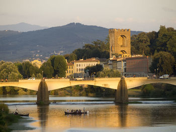 Arch bridge over river against sky