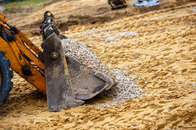 Wheel bulldozer bucket filled with gravel