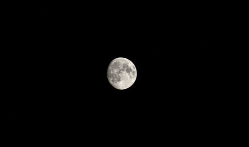 Low angle view of moon against clear sky at night