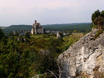 Old ruins by building against sky