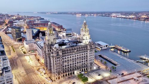 High angle view of buildings by river in city