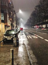 Man on city street at night