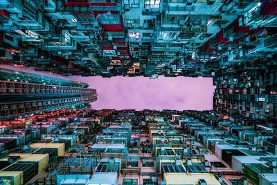 Directly below shot of illuminated buildings in city at night