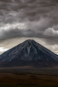View of volcanic mountain against cloudy sky