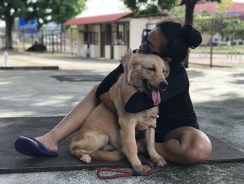 Dog sitting on floor in city
