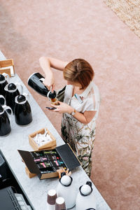 High angle view of woman sitting on table