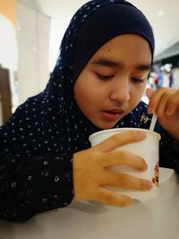 Close-up portrait of a boy drinking ice cream