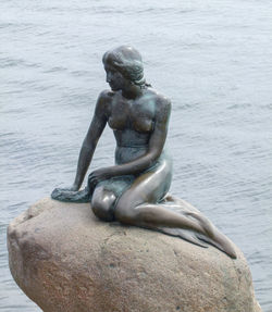 Statue on sea shore