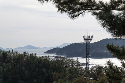 Scenic view of trees and mountains against sky and sea