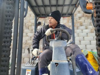 Side view of man working at construction site