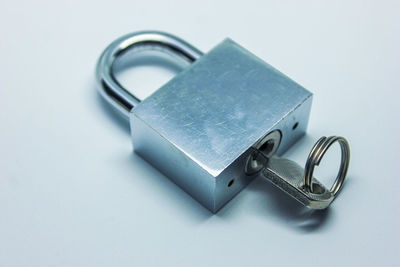 Close-up of padlock on white background