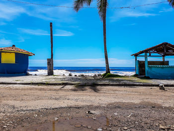 Hut on beach against sky