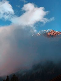 Low angle view of volcanic mountain against sky during sunset