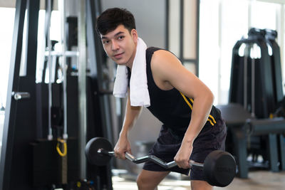 Young man exercising in gym