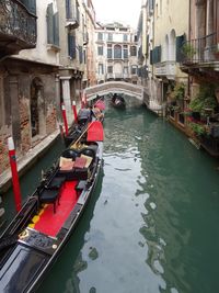 Boats in canal along buildings