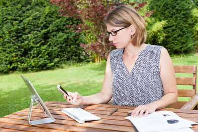 Young woman sitting on book