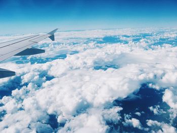 Aerial view of cloudscape over airplane wing