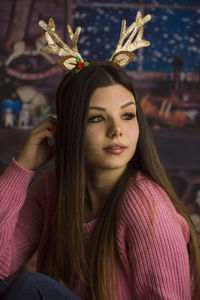 Portrait of young woman with christmas tree