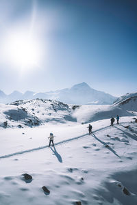 People skiing on snow covered mountain