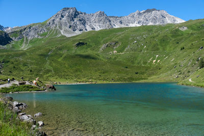 Scenic view of sea and mountains against sky