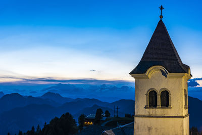 Low angle view of building against mountains and sky