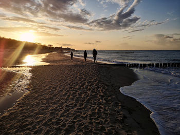 Scenic view of beach against sky during sunset