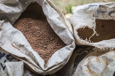 High angle view of soil in open sacks