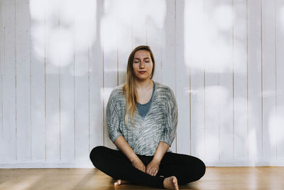 Woman meditating with eyes closed