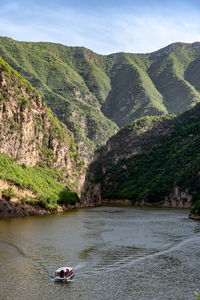 Scenic view of river amidst mountains