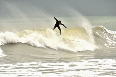 Silhouette man surfing in sea