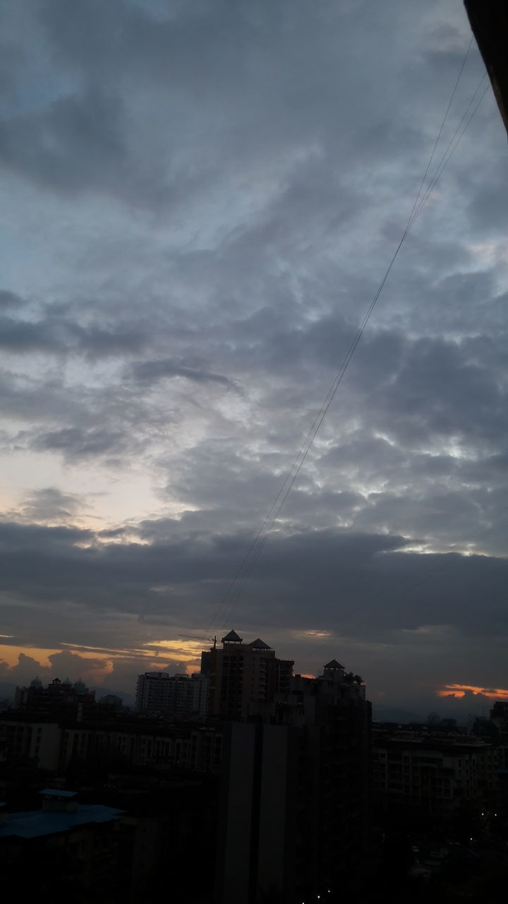 SILHOUETTE BUILDINGS IN CITY AGAINST DRAMATIC SKY