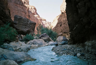 View of narrow stream along rocks