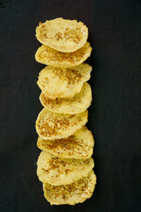 Close-up of bread on table against black background