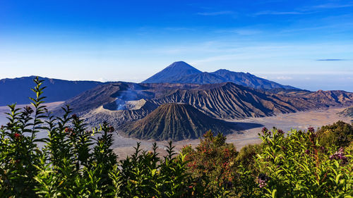 Scenic view of mountain range against blue sky