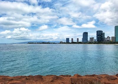 Sea and buildings against sky