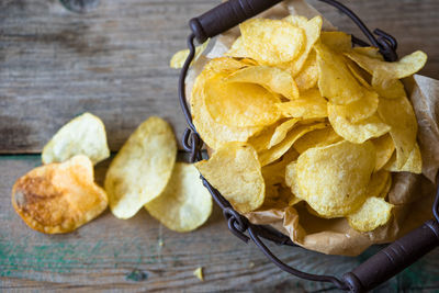 High angle view of fresh crunchy potato chips on table