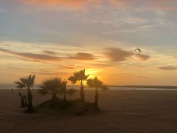 Scenic view of beach against sky during sunset