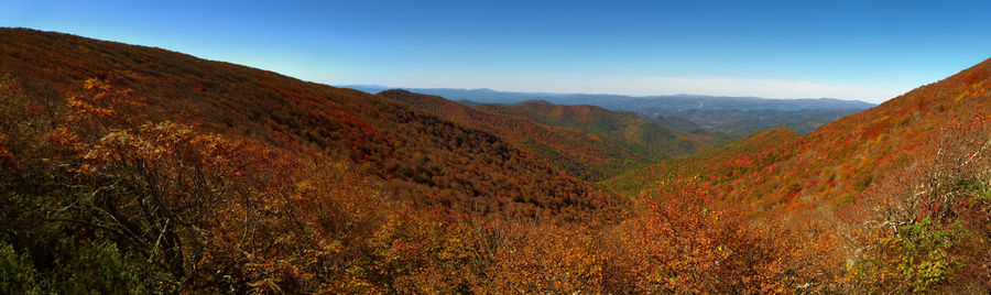 Scenic view of mountains against blue sky