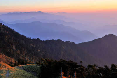 Scenic view of mountains against sky at sunset