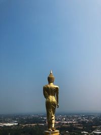 Statue of liberty against buildings in city
