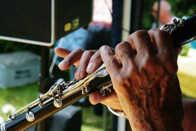 Close-up of man playing flute