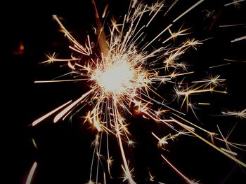 Low angle view of firework display at night