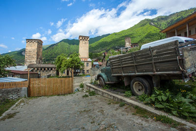 Panoramic shot of building by mountain against sky