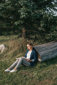 Young woman sitting on a land