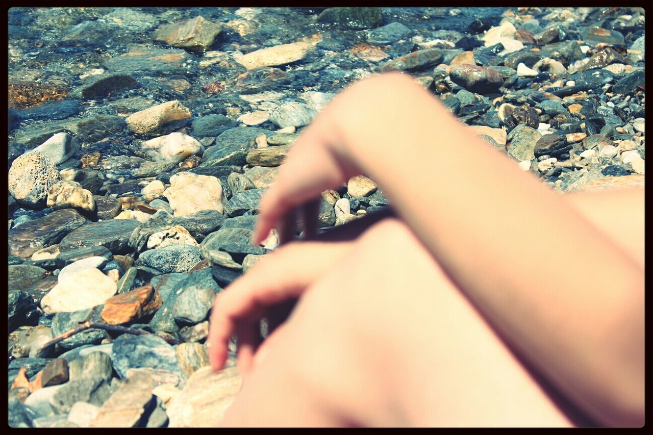 transfer print, auto post production filter, lifestyles, person, leisure activity, barefoot, low section, high angle view, part of, day, rock - object, close-up, outdoors, personal perspective, sunlight