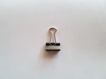 High angle view of paper clip against white background