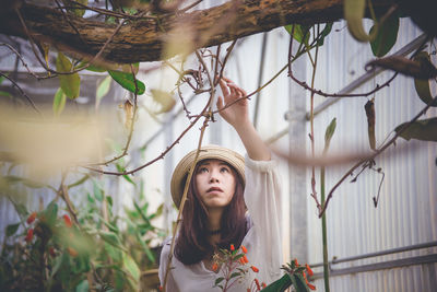 Portrait of young woman looking away outdoors