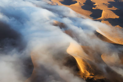 Aerial view of volcanic landscape against cloudy sky