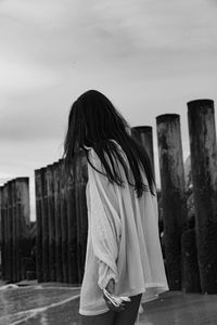Side view of woman standing against the sky
