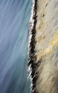 Full frame shot of rocks by sea